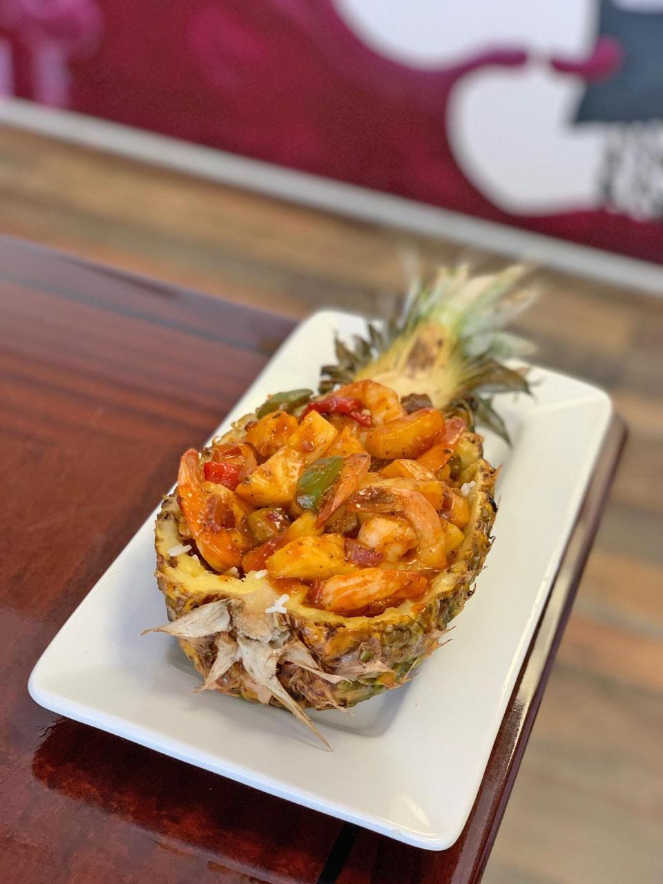 The Pink Salt pineapple shrimp boat is copious portion of diced pineapple and tail-on shrimp mixed with a sweet sauce and peppers.