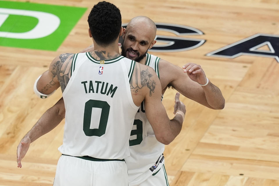 Boston Celtics forward Jayson Tatum (0) and guard Derrick White (9) celebrate after defeating the Indiana Pacers in overtime of Game 1 of the NBA Eastern Conference basketball finals, Tuesday, May 21, 2024, in Boston. (AP Photo/Michael Dwyer)