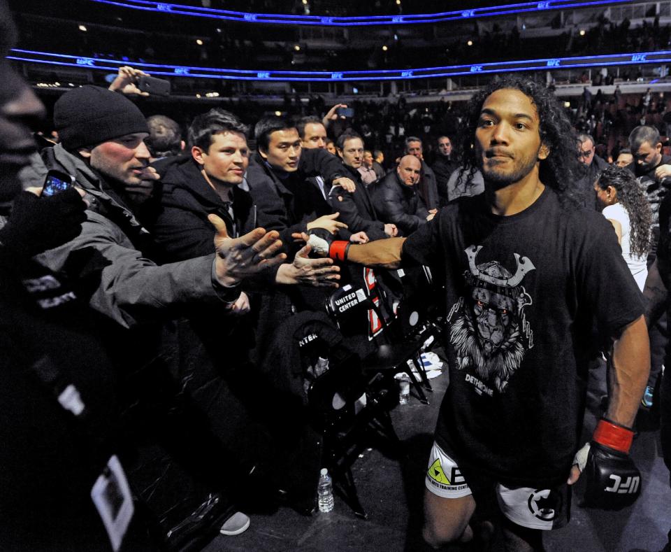 Benson Henderson celebrates with fans after defeating Josh Thomson during the main event of the UFC mixed martial arts match in Chicago, Saturday, Jan., 25, 2014. (AP Photo/Paul Beaty)