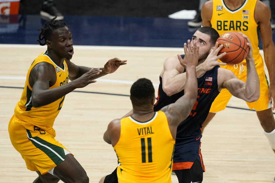 Illinois' Giorgi Bezhanishvili (15) looks to shoot as Baylor's Mark Vital (11) and Jonathan Tchamwa Tchatchoua (23) defend during the first half of an NCAA college basketball game Wednesday, Dec. 2, 2020, in Indianapolis. (AP Photo/Darron Cummings)