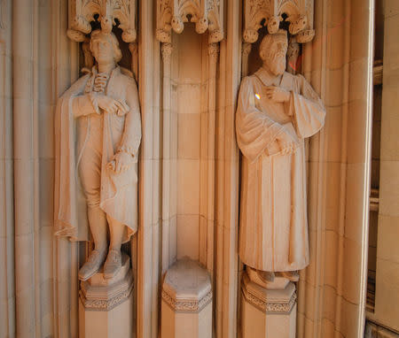 The empty plinth where a statue of Confederate commander General Robert E. Lee once stood is flanked by statues of Thomas Jefferson and the poet Sidney Lanier at the entrance to Duke University's Duke Chapel after officials removed the controversial statue early Saturday morning in Durham, North Carolina, U.S., August 19, 2017. REUTERS/Jason Miczek