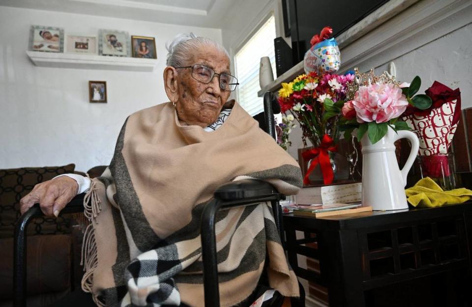Elvira Madrigal, who just celebrated her 107th birthday, is seen with flowers, a balloon, a tiara and more to the right. Photographed Tuesday, May 7, 2024 at her home in Fresno.