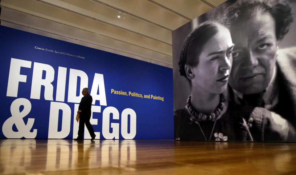 This Feb. 8, 2013 photo shows a giant image of artists Frida Kahlo and Diego Rivera at the entrance to the exhibition "Frida & Diego: Passion, Politics, and Painting," at the High Museum in Atlanta. The exhibit features more than 140 works, making it the largest exhibition of the couple's art ever displayed together. Atlanta’s High will be the only U.S. venue for the exhibition, which opens Feb. 14 and runs through May 12. (AP Photo/David Goldman)