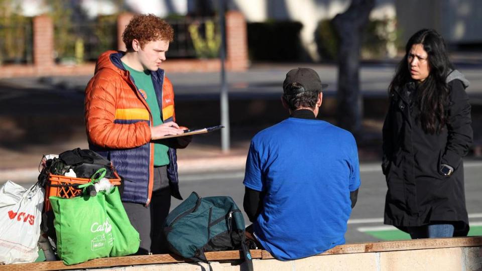 John Lynch, Tribune reporter, and Miriam Vargas a program manager at Transitions-Mental Health Association talk to Jason F. on Marsh Street in San Luis Obispo. The Point-In-Time Count of the county’s unhoused population took place on Jan. 23, 2024.