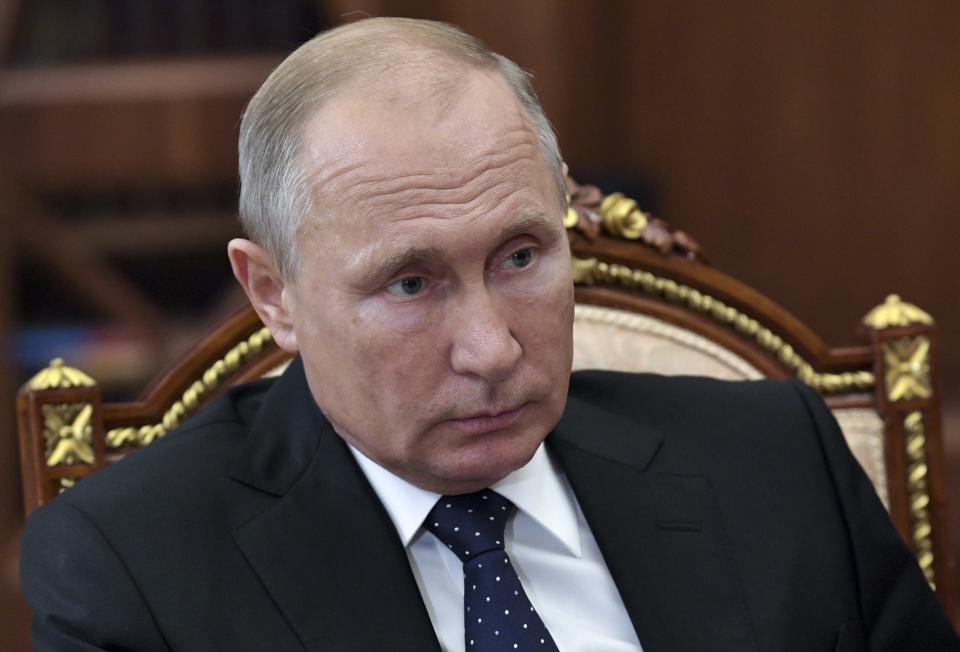 Russian President Vladimir Putin, listens during a meeting in the Kremlin in Moscow, Russia, Wednesday, Nov. 7, 2018. The Kremlin said Wednesday that Russia and the U.S. have agreed not to hold a full-fledged meeting of President Vladimir Putin and U.S. President Donald Trump in Paris, bowing to the French concern that the summit would distract public attention from the Armistice Day 100th anniversary. (Alexei Nikolsky, Sputnik, Kremlin Pool Photo via AP)