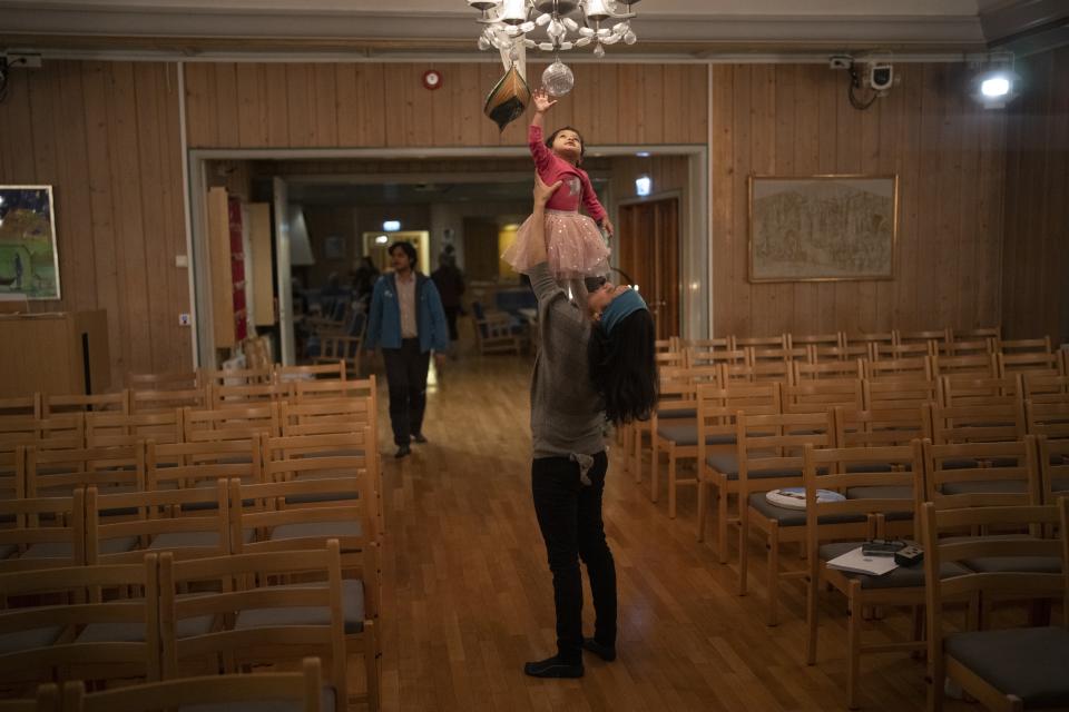 Neelu Singh holds her daughter Svalbie after a service at Svalbard Kirke in Longyearbyen, Norway, Sunday, Jan. 8, 2023. She and Svalbie started coming to church for the weekly "baby song hour." (AP Photo/Daniel Cole)