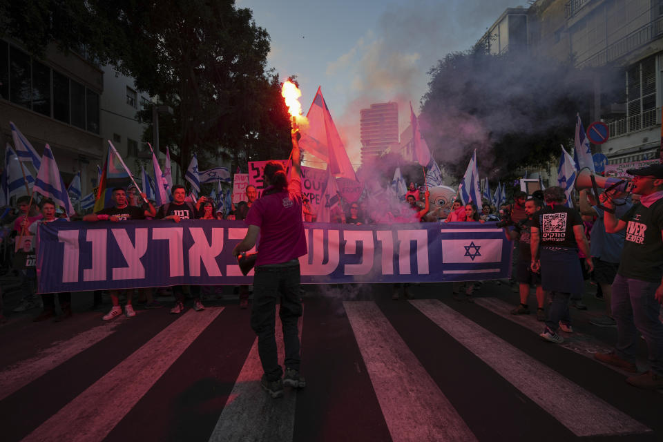 Israelis protest against plans by Prime Minister Benjamin Netanyahu's government to overhaul the judicial system, in Tel Aviv, Israel, Saturday, May 20, 2023. Hebrew on banner reads "free in our country". (AP Photo/Tsafrir Abayov)