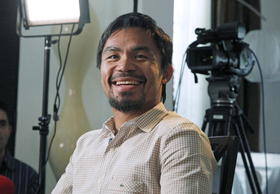 Manny Pacquiao, world champion boxer and Filipino congressman, smiles during a break while speaking about his views on same-sex marriage, and other subjects, during the taping of a segment of the entertainment TV show "Extra" at his home in Los Angeles on Wednesday, May 16, 2012. Pacquiao says he loves and supports gays and lesbians, even though he does not approve of gay marriage. Pacquiao has been criticized ever since he gave an interview to the examiner.com website in which he opposed President Barack Obama's support for gay marriage. (AP Photo/Reed Saxon)