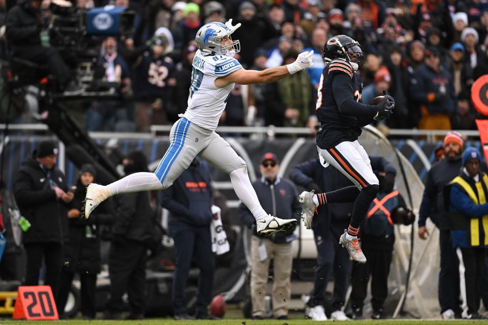 Bears defensive back Jaylon Johnson intercepts a pass intended for Lions tight end Sam LaPorta on fourth down during the second quarter on Sunday, Dec. 10, 2023, in Chicago.