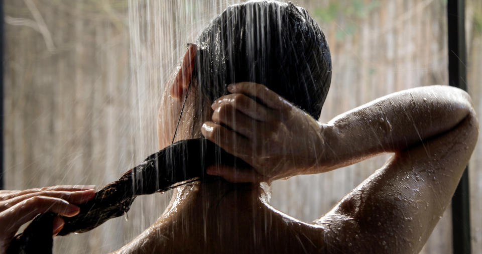 An image of a woman's head under the shower head