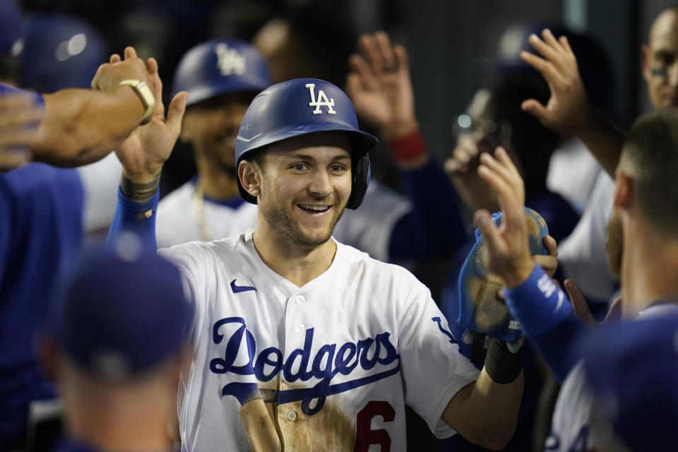 FILE - Los Angeles Dodgers' Trea Turner (6) celebrates in the dugout after scoring off of a double hit by Freddie Freeman during the eighth inning of a baseball game against the Milwaukee Brewers in Los Angeles, Tuesday, Aug. 23, 2022. The Philadelphia Phillies landed Trea Turner on Monday, Dec. 5, 2022, agreeing to a $300 million, 11-year contract with the dynamic shortstop. (AP Photo/Ashley Landis, File)