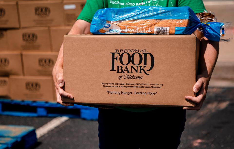 A volunteer prepares to deliver a box of food to a client during an event in July 2020. Organizers with nonprofits like Regional Food Bank, say donations of money or time are needed year round.