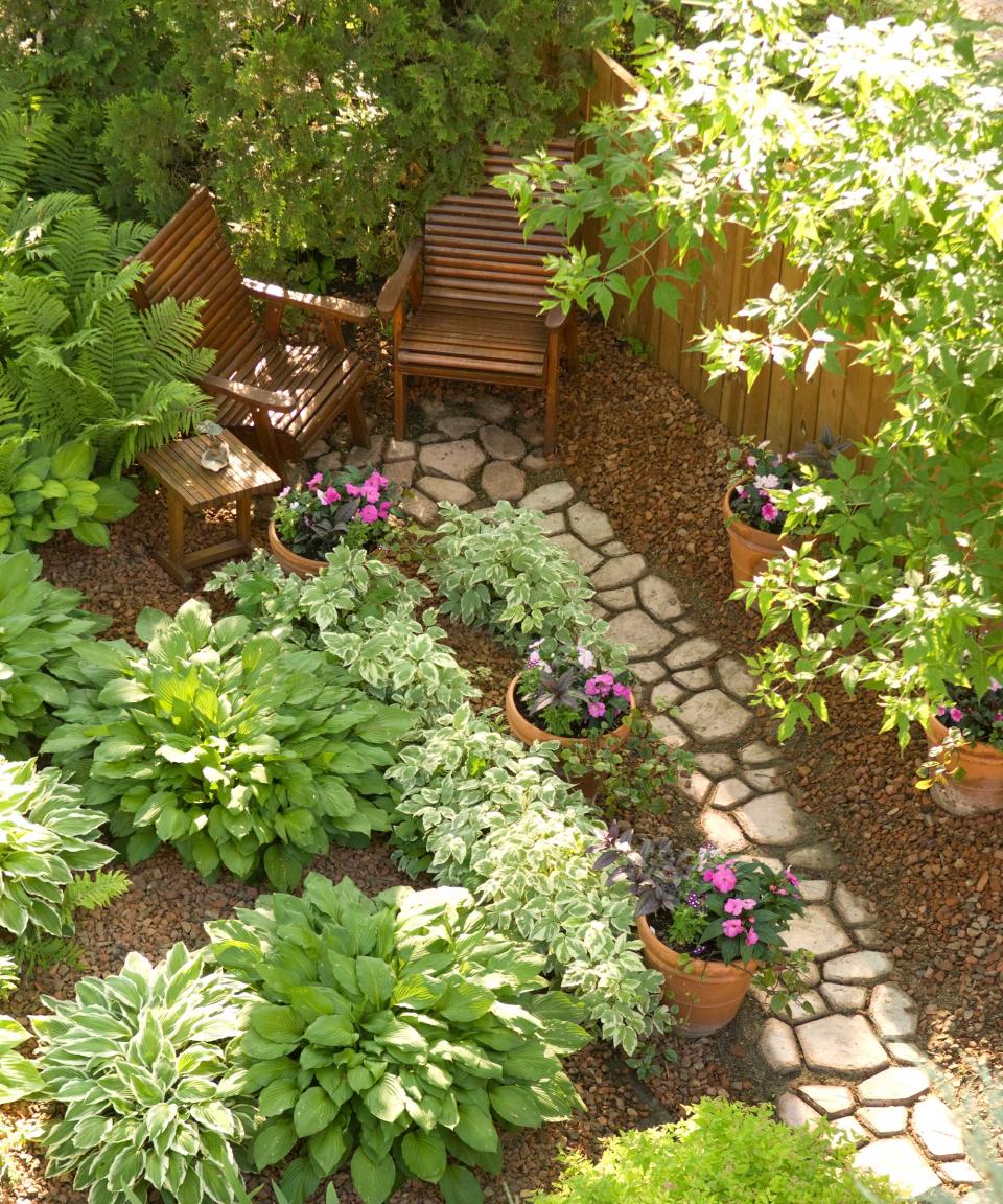 <p> A winding path of stepping stones leading the way to a tucked-away seating spot is easy to create and will give any plot an enchanting feel. Use reclaimed pavers, bricks, or even logs to keep costs down.  </p> <p> Surround with budget-friendly gravel or wood chippings in a contrasting color, planted up with pockets of lush foliage. These mounds of hostas create a cooling, jungle-like vibe and will thrive in the shade. Add a couple of containers too as a finishing touch. You can switch them up with seasonal blooms throughout the year. </p>