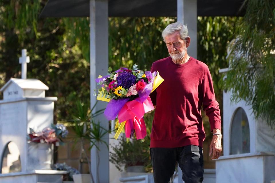 David Hunter lays flowers at the grave of his wife Janice Hunter (PA Wire)