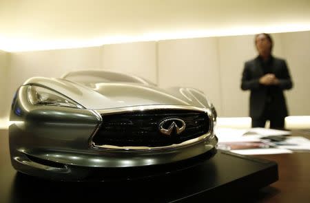 Infiniti chief designer Alfonso Albaisa stands behind a quarter sized model of the Infiniti Emerg E car during an interview with Reuters at Nissan Technical Center in Atsugi, south of Tokyo in this May 20, 2014 file photo. REUTERS/Yuya Shino/Files