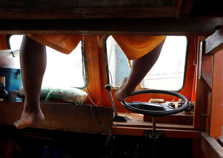 A Philippine fisherman uses his foot to steer his boat at the disputed Scarborough Shoal April 6, 2017. Picture taken April 6, 2017. REUTERS/Erik De Castro