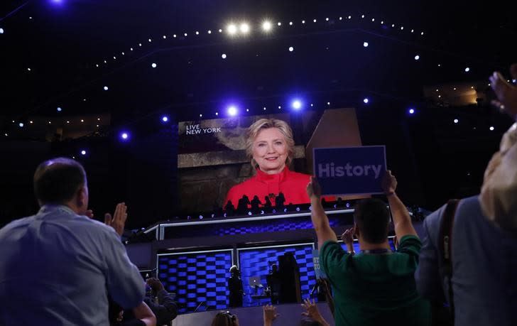 Democratic U.S. presidential nominee Hillary Clinton appears on a video monitor streamed live from New York at the Democratic National Convention in Philadelphia, Pennsylvania, U.S. July 26, 2016. REUTERS/Mark Kauzlarich 