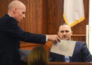 First Assistant District Attorney William McCauley shows a photo to witness North Attleboro police officer Edward Zimmer during the Aaron Hernandez's murder trial at Bristol County Superior Court in Fall River, Massachusetts February 11, 2015. REUTERS/Ted Fitzgerald/Pool (UNITED STATES - Tags: CRIME LAW SPORT FOOTBALL)