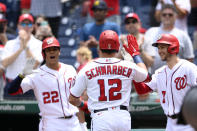 Washington Nationals' Kyle Schwarber celebrates his home run with Trea Turner (7) and Juan Soto (22) during the first inning of a baseball game against the San Francisco Giants, Sunday, June 13, 2021, in Washington. (AP Photo/Nick Wass)