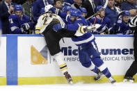 Tampa Bay Lightning center Barclay Goodrow (19) runs Boston Bruins defenseman Brandon Carlo (25) into the boards during the first period of an NHL hockey game Tuesday, March 3, 2020, in Tampa, Fla. (AP Photo/Chris O'Meara)