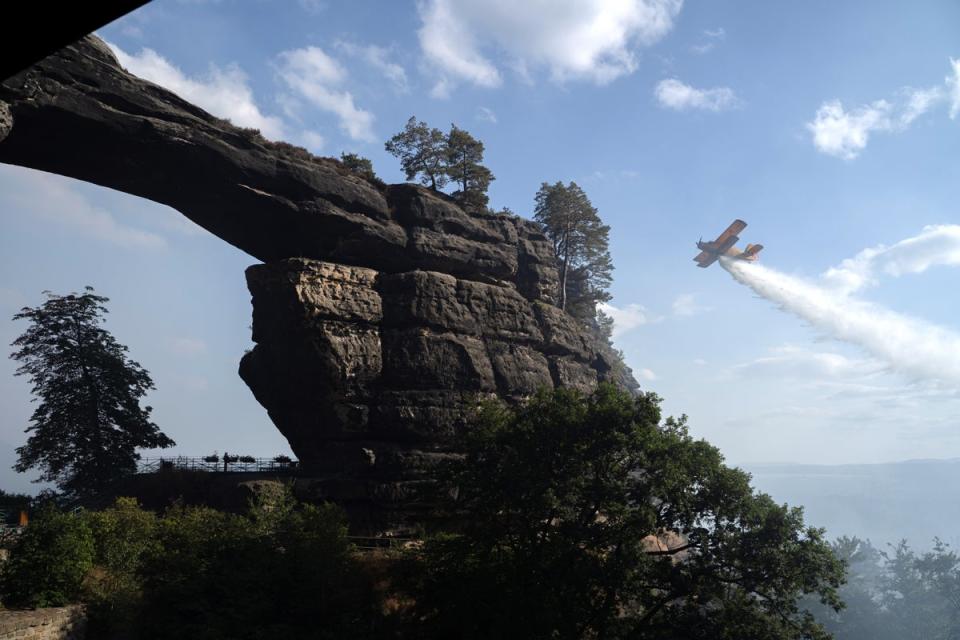 A plane drops water near the Pravcice Gate (EPA/Ray Baseley)