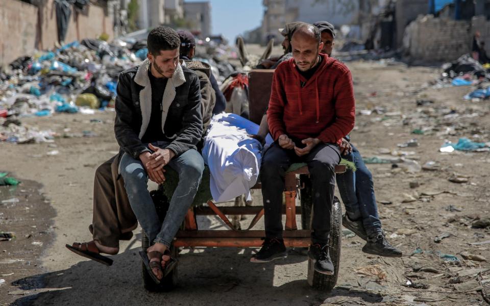 Gazans transport the body of a Palestinian killed in Thursday's deadly aid convoy incident