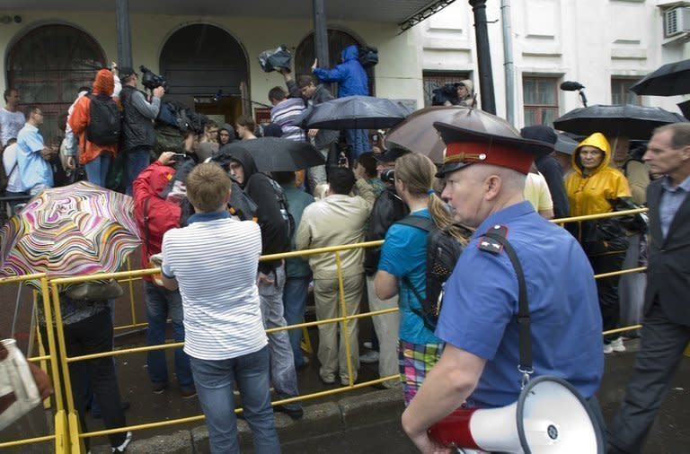 Journalists gather outside the courthouse in Kirov, northern Russia on July 18, 2013 for the trial of Russia's top opposition leader Alexei Navalny. The court on Thursday sentenced Navalny to five years in a penal colony after finding him guilty of embezzlement, a verdict which will disqualify one of President Vladimir Putin's fiercest critics from politics