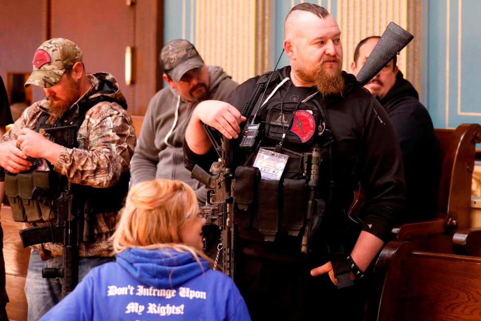 William Null, right, stands in the gallery of the Michigan Senate Chamber during the American Patriot Rally, organized by Michigan United for Liberty on April 30 to demand the reopening of businesses.