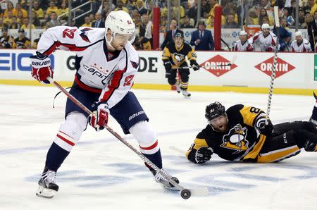 May 4, 2016; Pittsburgh, PA, USA; Washington Capitals center Evgeny Kuznetsov (92) skates with the puck in front of Pittsburgh Penguins right wing Phil Kessel (81) during the first period in game four of the second round of the 2016 Stanley Cup Playoffs at the CONSOL Energy Center. Mandatory Credit: Charles LeClaire-USA TODAY Sports