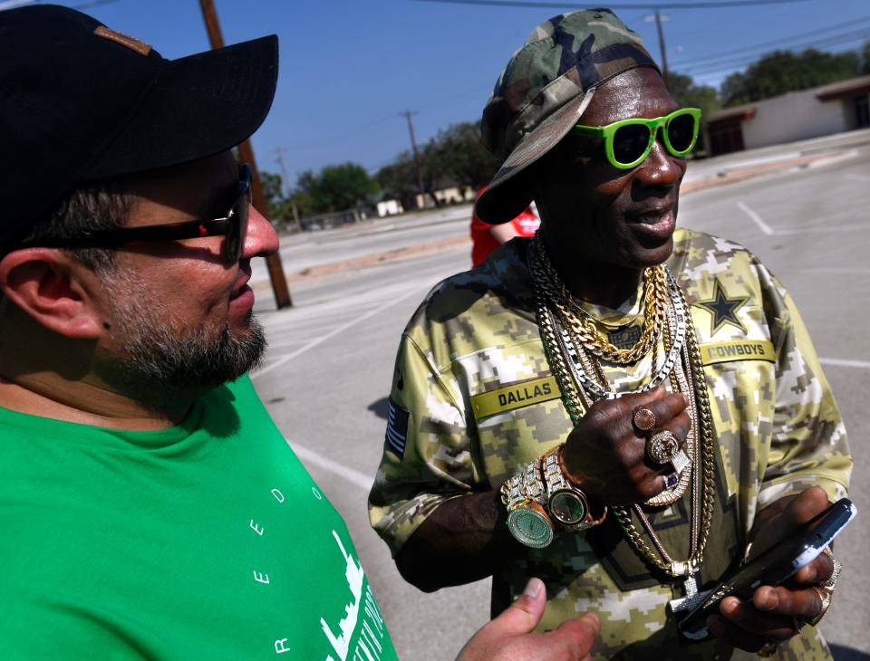 Patrick Jones, dressed as hip-hop artist Flavor Flav but who goes by the stage name "Chuck Jewels", speaks with Joey Devora before the Juneteenth parade Saturday morning. The procession led from the Abilene Convention Center to Stevenson Park