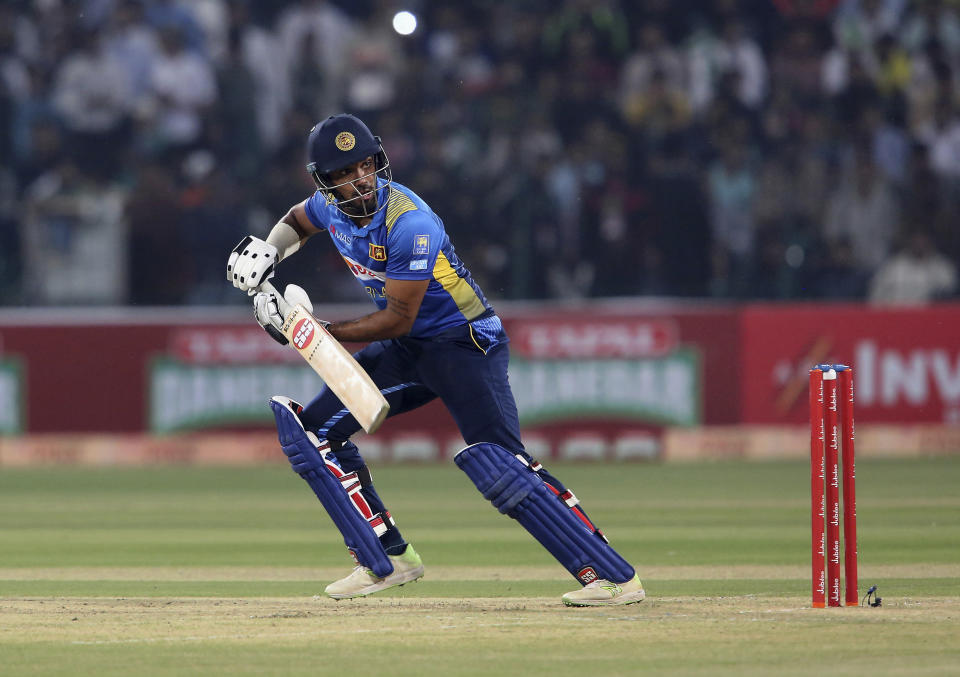 Sri Lankan batsman Danushka Gunathilaka follows the ball after playing a shot during 1st Twenty20 match against Pakistan at Gaddafi stadium in Lahore, Pakistan, Saturday, Oct. 5, 2019. (AP Photo/K.M. Chaudary)