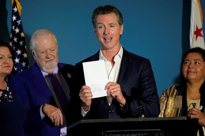 FILE PHOTO: California governor Gavin Newsom reacts after signing SB 113, which will enable the transfer of $331million in state funds to the National Mortgage Special Deposit Fund in San Diego, California