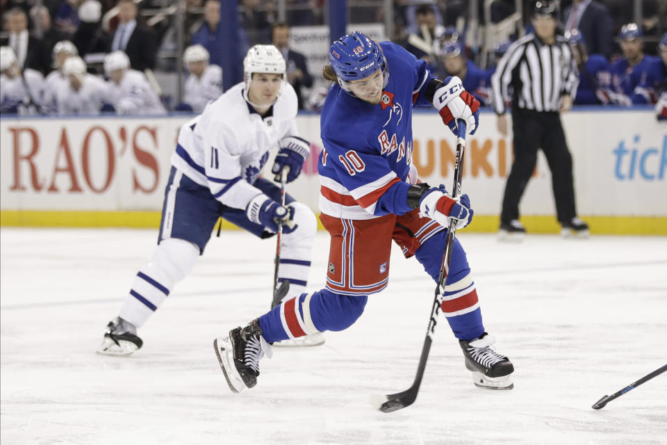 New York Rangers' Artemi Panarin (10) shoots the puck as Toronto Maple Leafs' Zach Hyman (11) watches during the second period of an NHL hockey game Friday, Dec. 20, 2019, in New York. (AP Photo/Frank Franklin II)