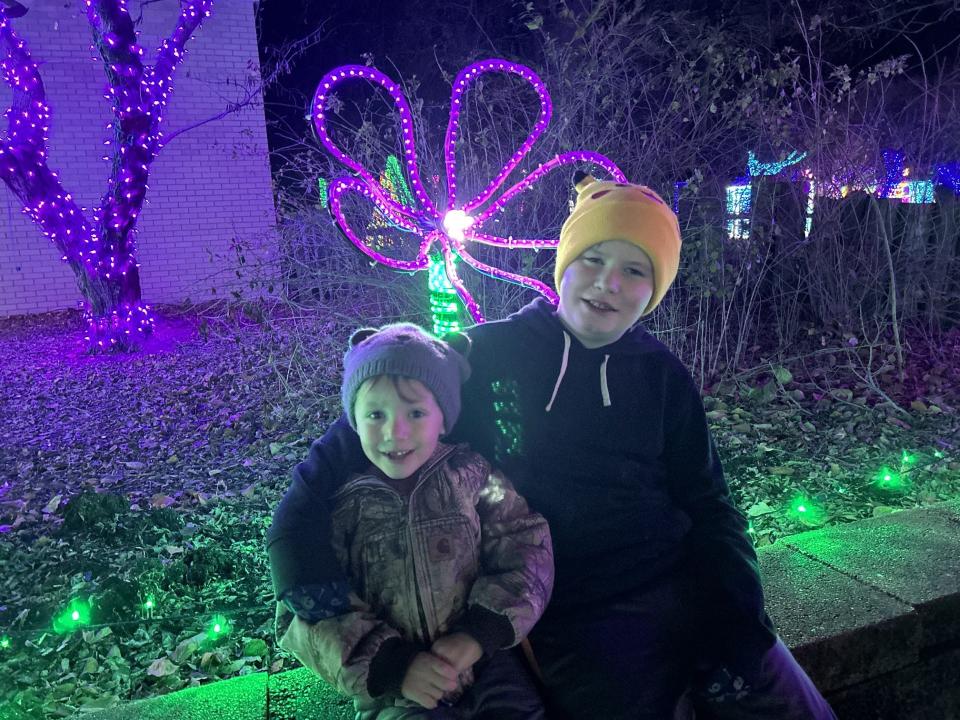 Four-year-old Oliver Manka and his 12-year-old uncle, Teddy Walton, enjoy the brisk night air during a recent trip to see Topeka Zoo Lights.