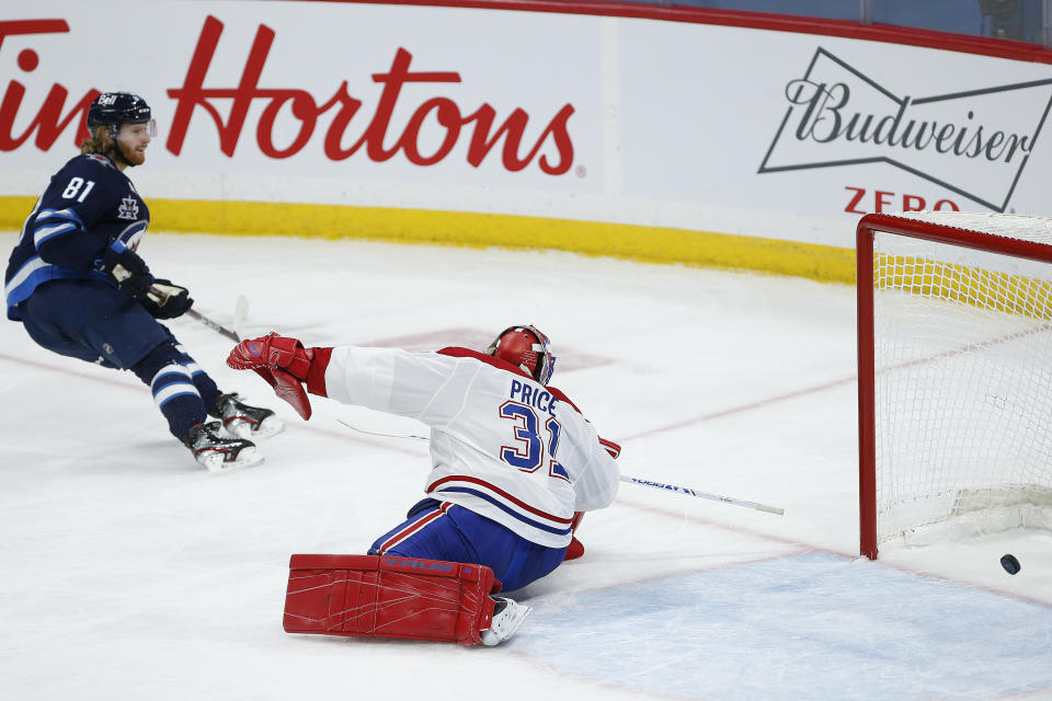 Winnipeg Jets' Kyle Connor (81) scores against Montreal Canadiens goaltender Carey Price (31) during second-period NHL hockey game action in Winnipeg, Manitoba, Thursday, Feb. 25, 2021. (John Woods/The Canadian Press via AP)