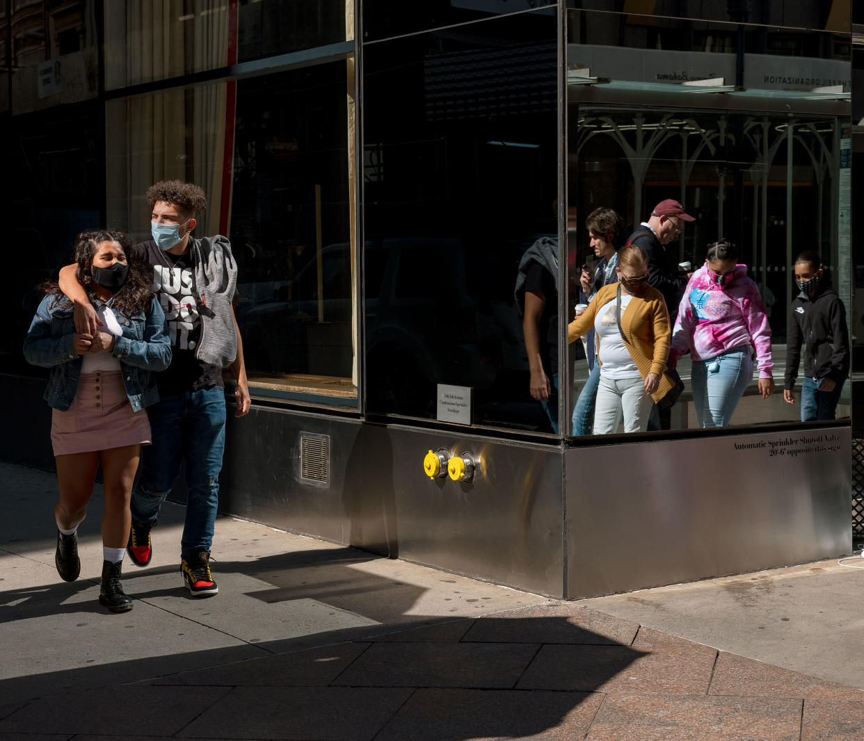 People wearing masks walk in Midtown Manhattan, at 45th st, and 5th ave on Oct. 3, 2020.