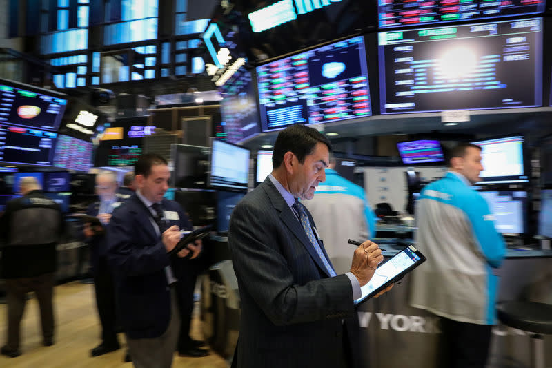 Traders work on the floor at the New York Stock Exchange (NYSE) in New York, U.S., March 20, 2019. REUTERS/Brendan McDermid