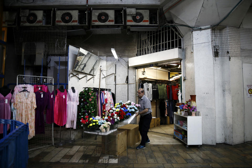 A vendor prepares to open a store at the Central Bus Station on May 29. (Photo: Corinna Kern/Reuters)