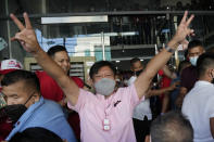 Presidential candidate Ferdinand "Bongbong" Marcos Jr. gestures as he greets the crowd outside his headquarters in Mandaluyong, Philippines on Wednesday, May 11, 2022. Marcos, the namesake son of longtime dictator Ferdinand Marcos, apparent landslide victory in the Philippine presidential election is raising immediate concerns about a further erosion of democracy in Asia and could complicate American efforts to blunt growing Chinese influence and power in the Pacific. (AP Photo/Aaron Favila)