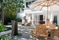 <p>This shady patio is the perfect place to spend the summer months. (Realtor.com) </p>