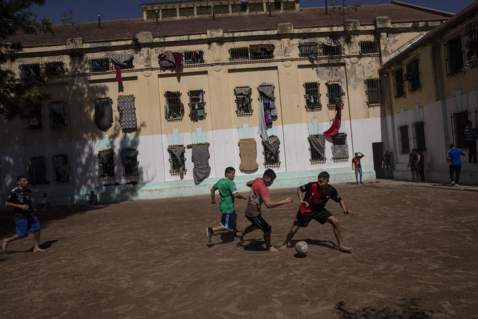 Inmates play soccer in the courtyard outside their evangelical cellblock at the Correctional Institute Model U.I, Dr. Cesar R Tabares, known as Penal Unit 1 in Coronda, Santa Fe province, Argentina, Friday, Nov. 19, 2021. Many here began peddling drugs as teenagers and got stuck in a spiral of violence that led some to their graves and others to overcrowded prisons divided between two forces: drug lords and preachers. (AP Photo/Rodrigo Abd)