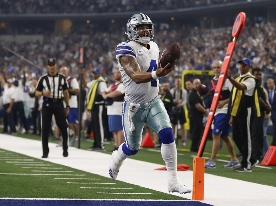 Dallas Cowboys quarterback Dak Prescott (4) runs into the end zone for a touchdown in the first half of an NFL football game against the Jacksonville Jaguars in Arlington, Texas, Sunday, Oct. 14, 2018. (AP Photo/Ron Jenkins)