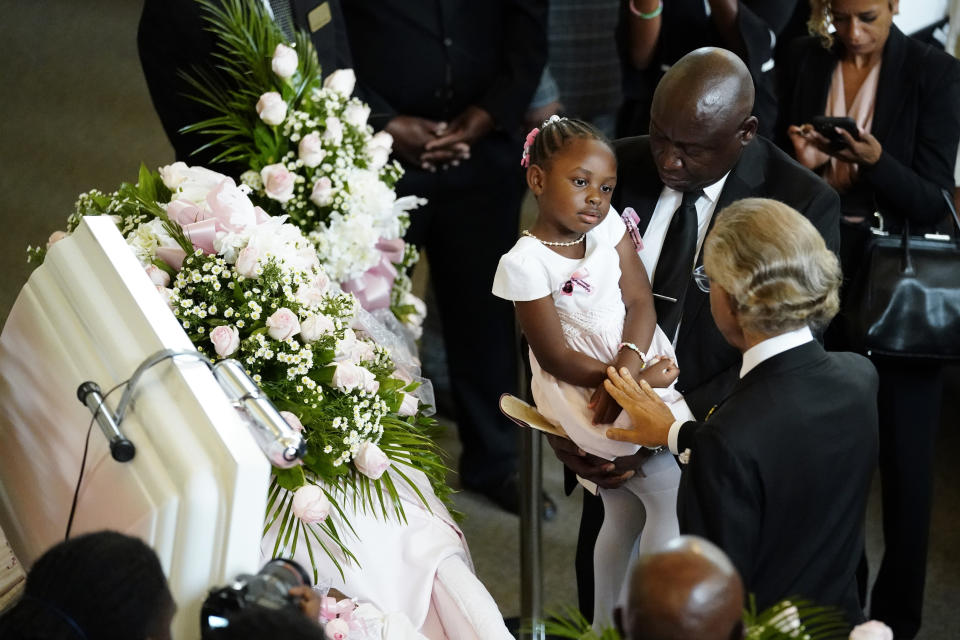 Rev. Al Sharpton, right, comforts a child during a funeral service for her mother Brianna Grier Thursday, Aug. 11, 2022, in Atlanta. The 28-year-old Georgia woman died after she fell from a moving patrol car following her arrest. (AP Photo/John Bazemore)