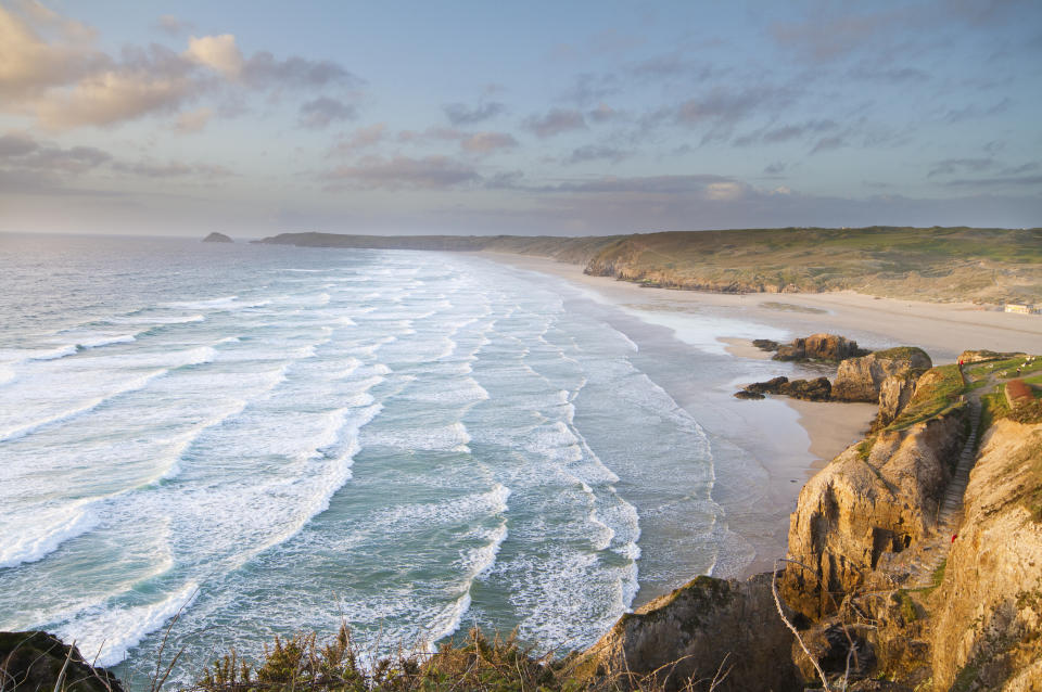 Clifftop view of waves breaking at Perranporth Beach, Cornwall. Longest beach in Cornwall, on the Southwest coastal path