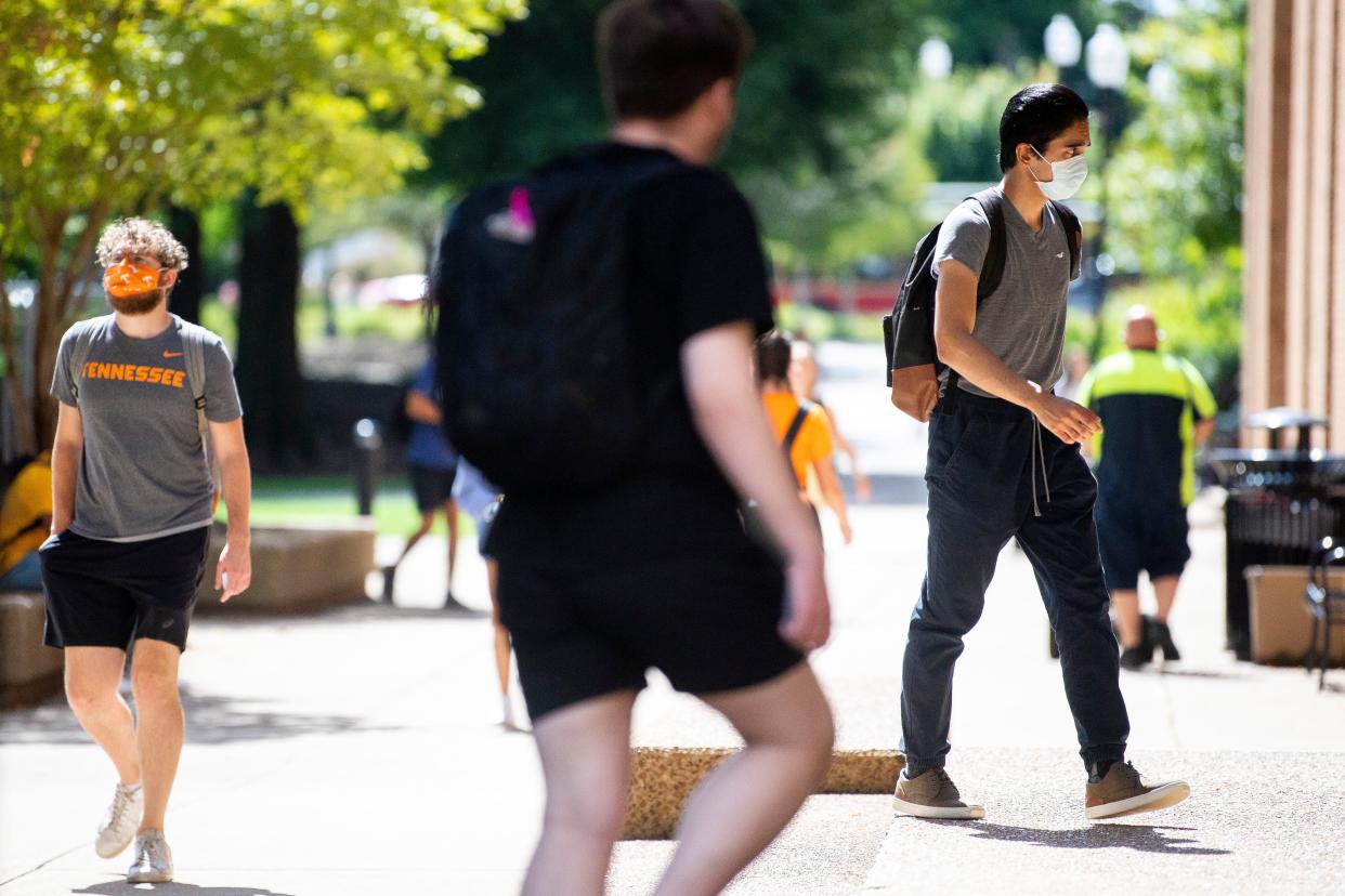 Students mask up while entering a building on the first day of fall classes at the University of Tennessee at Knoxville on Wednesday, August 18, 2021. 