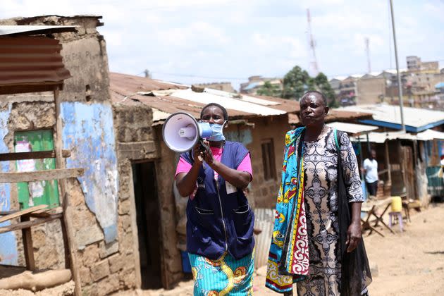 A health volunteer walks through slums in Nairoba, Kenya, informing residents about the coronavirus pandemic. More than 2.5 million people live n impoverished conditions in the city.