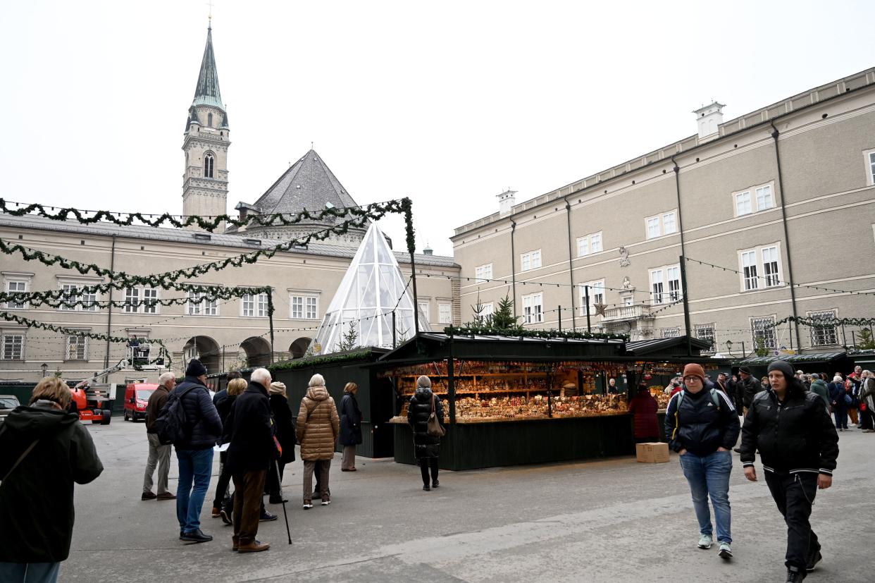 Visitors walk past stalls at the old city in Salzburg, Austria, on November 12, 2021, during the ongoing coronavirus (Covid-19) pandemic. - Austrian Chancellor Schallenberg said on November 12, that he wanted to introduce a nationwide lockdown for those not vaccinated against or recovered from the coronavirus, as cases rapidly rise. The states of Upper Austria and Salzburg, which have seen some of the worse case rates, are already introducing the lockdown for the unvaccinated as of Monday, November 15. 

  - Austria OUT (Photo by BARBARA GINDL / APA / AFP) / Austria OUT (Photo by BARBARA GINDL/APA/AFP via Getty Images)