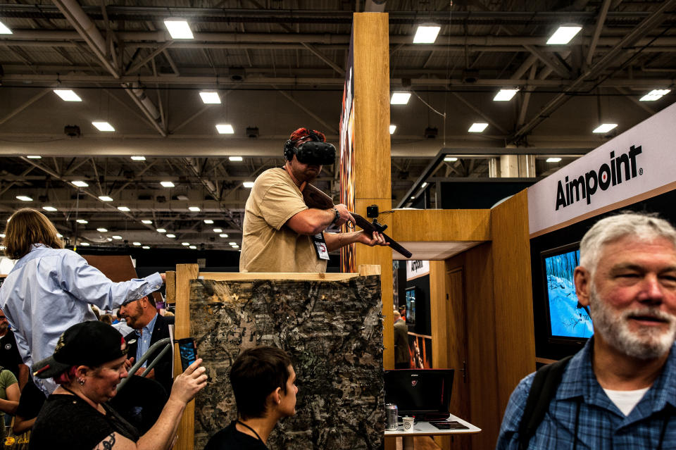 A man takes part in a virtual reality simulation on the expo floor Saturday.