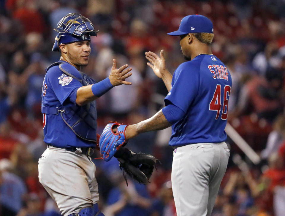 Chicago Cubs catcher Willson Contreras, left, and relief pitcher Pedro Strop celebrate following a baseball game against the St. Louis Cardinals Sunday, July 29, 2018, in St. Louis. The Cubs won 5-2. (AP Photo/Jeff Roberson)