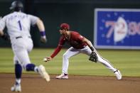 Arizona Diamondbacks second baseman Josh Rojas, right, flips the ball to second base to get out Colorado Rockies' Garrett Hampson (1) during the fourth inning of a baseball game Sunday, Aug. 7, 2022, in Phoenix. (AP Photo/Ross D. Franklin)